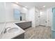 Bright bathroom with dual vanities, quartz countertop, and wood-look tile flooring at 4080 Bonfire Dr, Odessa, FL 33556
