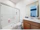 Bright bathroom featuring a glass-enclosed shower with white subway tile and modern fixtures at 4080 Bonfire Dr, Odessa, FL 33556