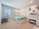 Stylized bedroom featuring a four-poster bed frame, neutral carpet, and a light blue accent wall at 4080 Bonfire Dr, Odessa, FL 33556