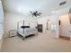Spacious bedroom features a four-poster bed and ceiling fan at 4080 Bonfire Dr, Odessa, FL 33556