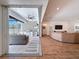 Bright open-concept living room connects seamlessly to outdoor kitchen through sliding glass doors at 4080 Bonfire Dr, Odessa, FL 33556