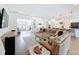 Open-concept living room and kitchen with hardwood floors, a sectional sofa, and seamless flow for entertaining at 4080 Bonfire Dr, Odessa, FL 33556