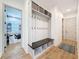 Hallway mudroom featuring bench, storage cubbies, and coat hooks at 4080 Bonfire Dr, Odessa, FL 33556
