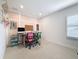 A neutral-toned office featuring a computer, a printer, and two rolling desk chairs at 4080 Bonfire Dr, Odessa, FL 33556