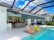 Covered pool area with in-pool seating and a retractable awning for shade at 4080 Bonfire Dr, Odessa, FL 33556