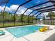 Relaxing pool with lounge chairs, outdoor dining, and a screened enclosure at 4080 Bonfire Dr, Odessa, FL 33556