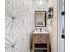 Chic powder room featuring a patterned accent wall and stylish vanity at 4080 Bonfire Dr, Odessa, FL 33556
