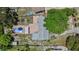 Overhead view of a single Gathering home, a patio, and a kidney-shaped pool surrounded by grass and trees at 4530 Catalonia S Way, St Petersburg, FL 33712