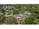 The home with a pool is surrounded by lush greenery in an established neighborhood, as seen from this aerial perspective at 4530 Catalonia S Way, St Petersburg, FL 33712