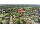 Panoramic view of a residential community surrounded by mature trees, a lake, and a golf course at 4530 Catalonia S Way, St Petersburg, FL 33712