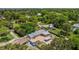 An aerial view reveals a home with spacious fenced-in yard, a pool, and views of the surrounding green neighborhood at 4530 Catalonia S Way, St Petersburg, FL 33712