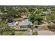 Aerial view of home featuring an inviting pool area, surrounded by mature trees, and a well-kept neighborhood at 4530 Catalonia S Way, St Petersburg, FL 33712