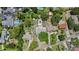 Aerial view of a single Gathering home and community featuring mature trees and lush landscaping at 4530 Catalonia S Way, St Petersburg, FL 33712
