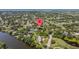 Expansive view of a residential neighborhood near a lake, mature trees, a road and a golf course at 4530 Catalonia S Way, St Petersburg, FL 33712
