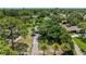 Aerial view of home showcases the expansive yard with mature trees, long driveway and verdant neighborhood surroundings at 4530 Catalonia S Way, St Petersburg, FL 33712