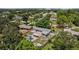 This aerial shot captures a pool home with verdant landscaping, a fenced-in yard, and a charming neighborhood setting at 4530 Catalonia S Way, St Petersburg, FL 33712