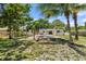 A backyard view showcases a pool, patio cover, lush landscaping, and a relaxing hammock at 4530 Catalonia S Way, St Petersburg, FL 33712