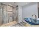 Bathroom features a unique wood look shower and a blue glass bowl sink on a tree stump at 4530 Catalonia S Way, St Petersburg, FL 33712