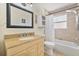 Bathroom featuring a granite vanity top, framed mirror, and shower/tub combo at 4530 Catalonia S Way, St Petersburg, FL 33712