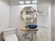 Bathroom features wood look shower, unique mirror, and blue glass bowl sink on a tree stump at 4530 Catalonia S Way, St Petersburg, FL 33712
