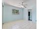 Bedroom featuring tile floors, window, ceiling fan, and light blue walls at 4530 Catalonia S Way, St Petersburg, FL 33712