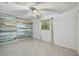Bedroom showcases a modern accent wall with light tile floors and a window view at 4530 Catalonia S Way, St Petersburg, FL 33712