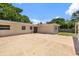 An exterior view of the backyard features a large patio and an attached concrete patio at 4530 Catalonia S Way, St Petersburg, FL 33712