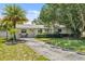 Attractive single-story home featuring mature landscaping, a well-maintained lawn, and a cozy front patio at 4530 Catalonia S Way, St Petersburg, FL 33712