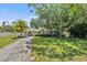 Inviting single-story home boasts mature trees, a well-kept lawn, and an attractive front facade at 4530 Catalonia S Way, St Petersburg, FL 33712