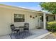 Cozy front porch area with seating, a decorative rug, and an inviting entrance enhances the home's charm at 4530 Catalonia S Way, St Petersburg, FL 33712