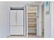 Kitchen featuring stainless steel refrigerator and large pull out pantry shelves at 4530 Catalonia S Way, St Petersburg, FL 33712