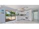 Bright kitchen featuring white cabinetry, views of the backyard pool area, and modern appliances, creating a functional design at 4530 Catalonia S Way, St Petersburg, FL 33712