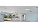 Bright, updated kitchen with white cabinets, modern appliances, and views of the outdoor pool area through sliding doors at 4530 Catalonia S Way, St Petersburg, FL 33712