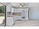 Bright kitchen featuring white cabinets, modern appliances, and a light-filled view to the yard at 4530 Catalonia S Way, St Petersburg, FL 33712