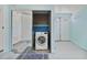 Laundry room with closet, washing machine, and an exterior door at 4530 Catalonia S Way, St Petersburg, FL 33712