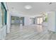 Spacious living area with neutral paint, modern flooring, and access to both the kitchen and backyard at 4530 Catalonia S Way, St Petersburg, FL 33712