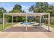 A refreshing backyard pool features a patio cover and lounge chairs for comfortable outdoor living at 4530 Catalonia S Way, St Petersburg, FL 33712