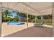 A refreshing backyard pool features a patio cover, lounge chairs and lush landscaping at 4530 Catalonia S Way, St Petersburg, FL 33712