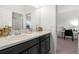 Bathroom featuring double sinks, granite countertop, and well-lit mirror at 4607 Los Robles Ct, Palmetto, FL 34221