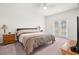 Bright bedroom with neutral decor, ceiling fan, and natural light from the double doors at 4607 Los Robles Ct, Palmetto, FL 34221