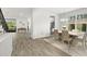 Light and bright dining room featuring wood floors, a large window, and elegant chandelier at 4607 Los Robles Ct, Palmetto, FL 34221