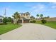 Beautiful two-story home with a well-manicured lawn, three-car garage, and a charming second-story balcony at 4607 Los Robles Ct, Palmetto, FL 34221