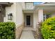 Inviting front entrance with a dark blue door, stone accents, and manicured landscaping at 4607 Los Robles Ct, Palmetto, FL 34221