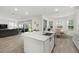 Open-concept kitchen featuring a large island, modern sink, and seamless flow to the living and dining areas at 4607 Los Robles Ct, Palmetto, FL 34221