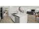Modern kitchen with a large island, stainless steel appliances, and an open view of the staircase and living area at 4607 Los Robles Ct, Palmetto, FL 34221