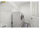 Well-lit laundry room equipped with modern washer and dryer units and shelving at 4607 Los Robles Ct, Palmetto, FL 34221