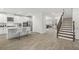 Open-concept living area with a modern kitchen, staircase, and a seamlessly connected living room, promoting a spacious feel at 4607 Los Robles Ct, Palmetto, FL 34221