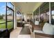 Covered patio featuring woven furniture, neutral decor, and views of the fenced backyard at 4607 Los Robles Ct, Palmetto, FL 34221