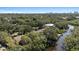 An expansive aerial view highlighting the home's waterfront location and lush greenery at 4722 W Laurel Rd, Tampa, FL 33629
