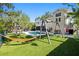 Spacious backyard with lush green lawn, pool, swing set, and hammock at 4722 W Laurel Rd, Tampa, FL 33629